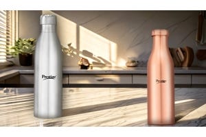 A silver stainless steel bottle and a copper bottle from Prestige placed on a kitchen counter