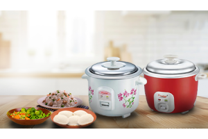 Two Prestige Electric Rice Cookers with prepared food on a kitchen table