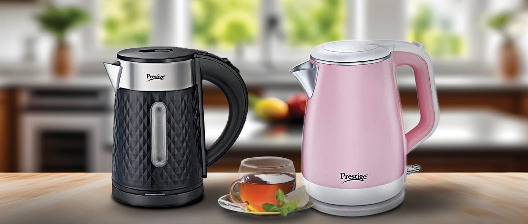 Black and pink electric kettles with a cup of tea on a kitchen counter