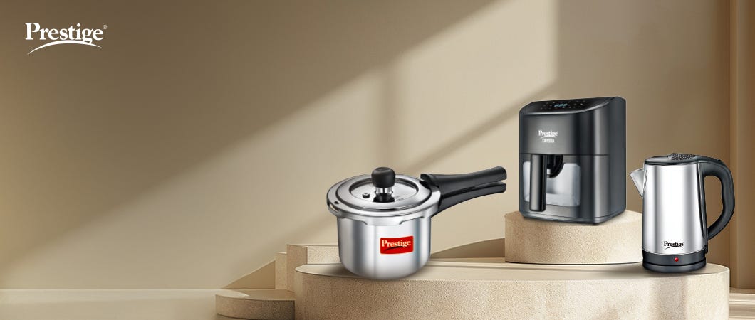 Prestige kitchen appliances, featuring a stainless steel pressure cooker, air fryer, and kettle, displayed in a modern setup for essential home cooking in 2025.